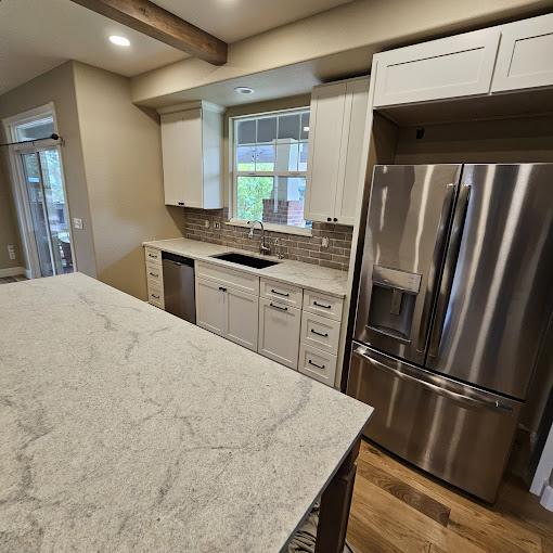 A kitchen with an island and stainless steel appliances