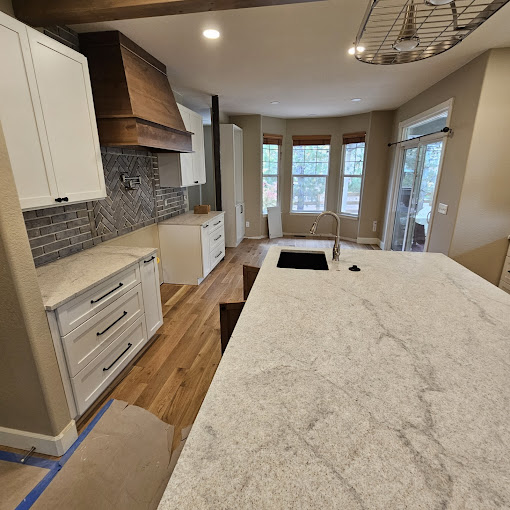 A large kitchen with a center island in the middle of the room