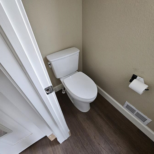 A white toilet sitting next to a white door